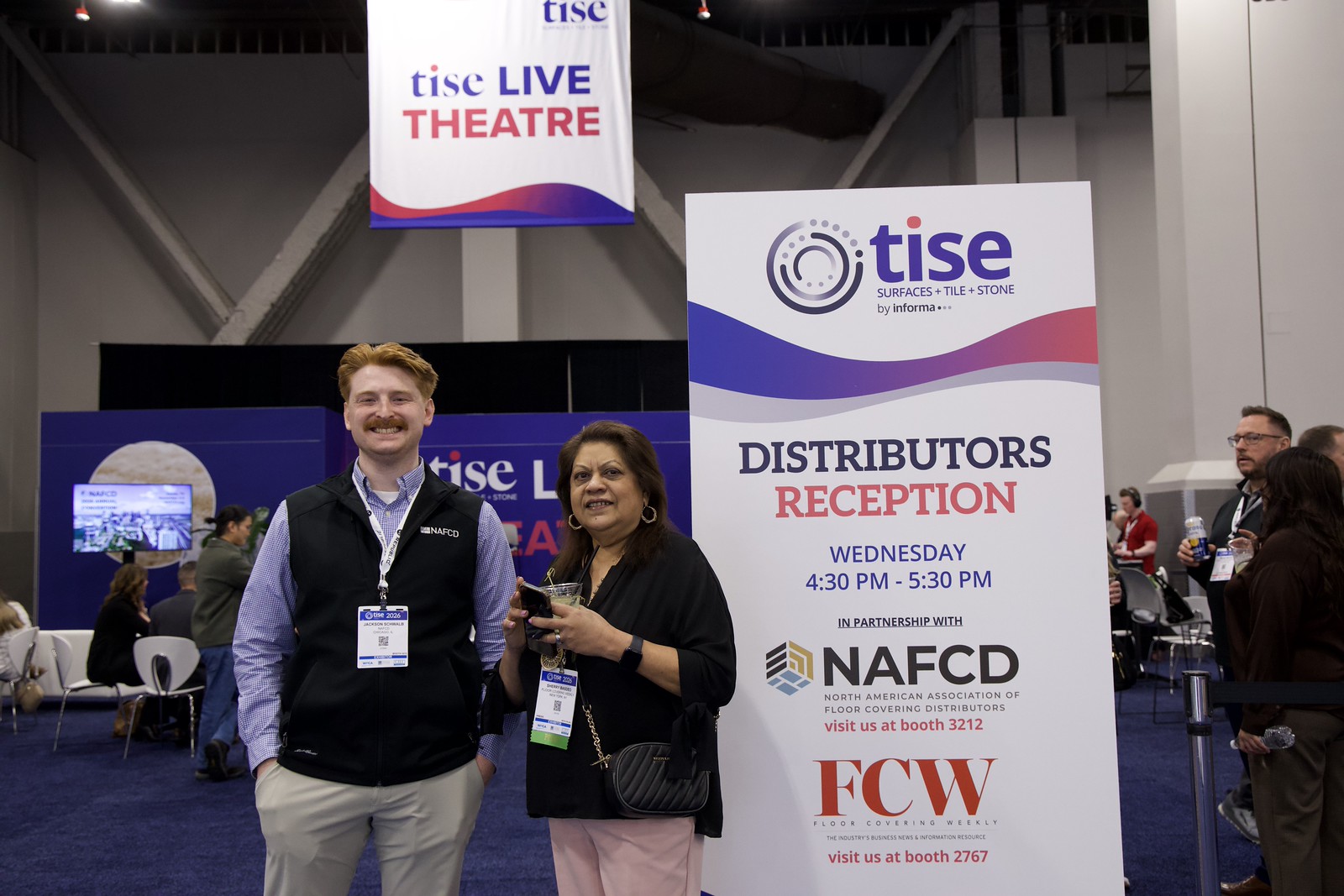 Attendees by the distributor reception sign and TISE Live Theatre at TISE 2026