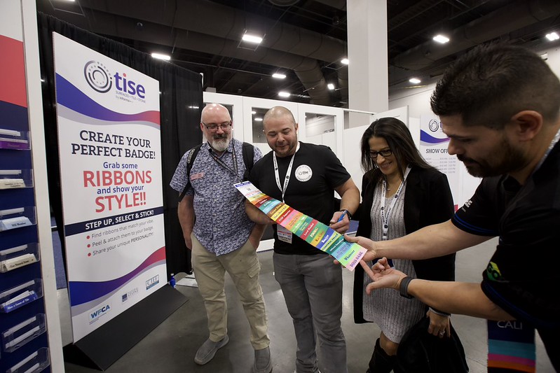 The badge-ribbon station in the organizer’s TISE 2026 highlights.